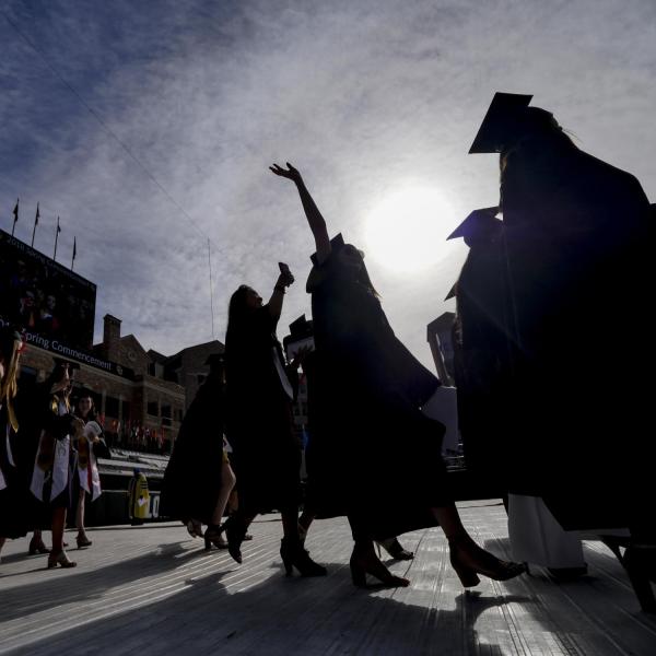 2018 graduates process onto Folsom Field