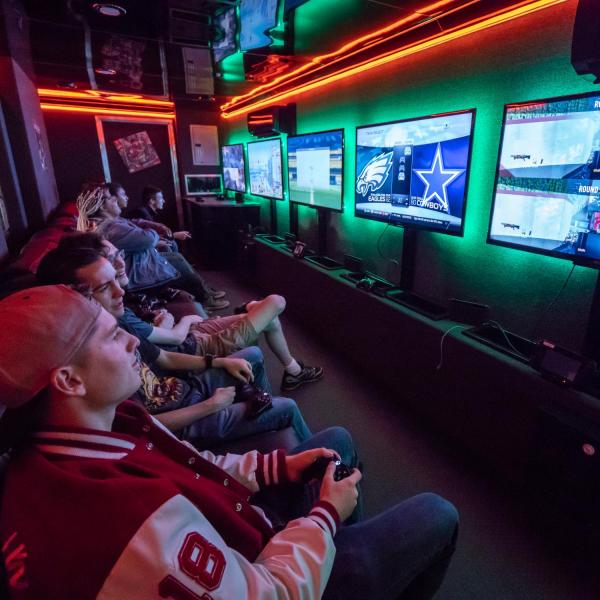 Students playing console games inside a Nintendo game trailer