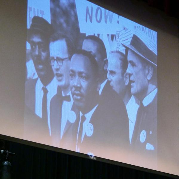 An image of Martin Luther King Jr. and others is projected on a large screen at the 2018 MLK Jr. Day celebration at the Old Main chapel on the CU Boulder campus. (Photo by Glenn Asakawa/University of Colorado)
