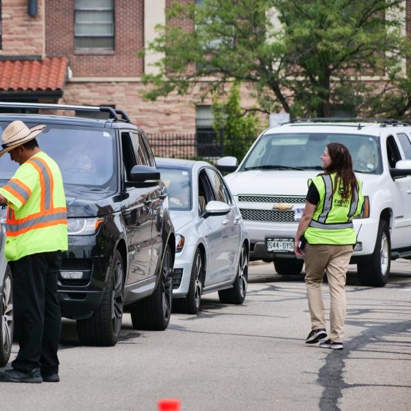 volunteers direct traffic on campus