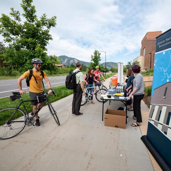 Cyclists check in at the Biofrontiers station by the Jennie Smoly Caruthers Biotechnology Building on the CU Boulder East Campus during the 2019 Bike to Work Day in Boulder. (Photo by Glenn Asakawa/University of Colorado)