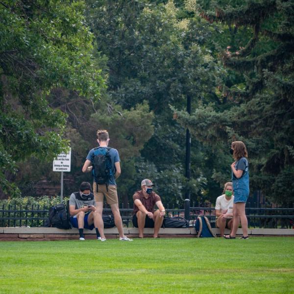 students outside in a group of six people