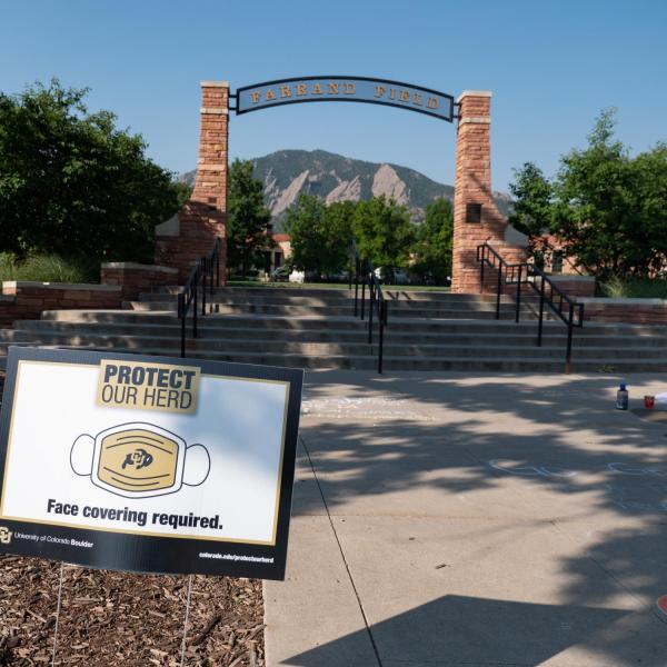 A Protect Our Herd–face covering required sign at the entrance of Farrand Field
