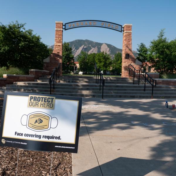 A Protect Our Herd–face covering required sign at the entrance of Farrand Field