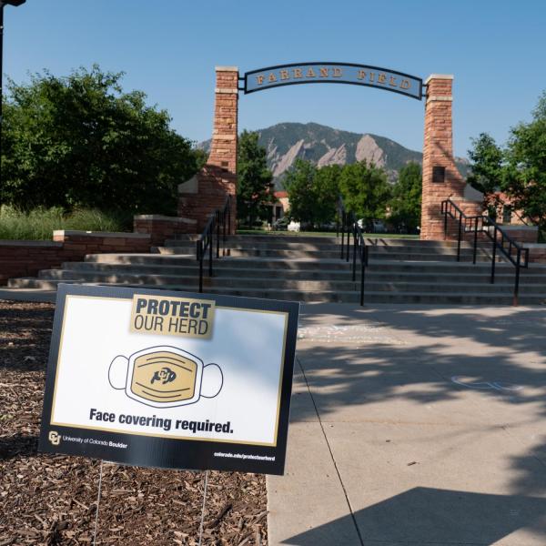 A Protect Our Herd–face covering required sign at the entrance of Farrand Field