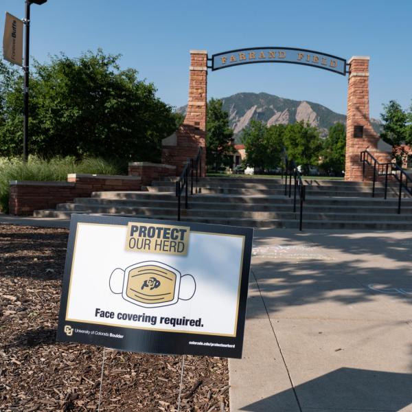 A Protect Our Herd–face covering required sign at the entrance of Farrand Field