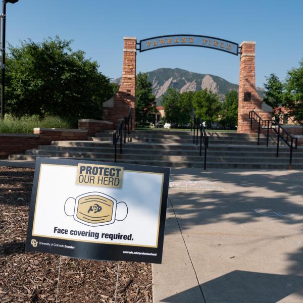 A Protect Our Herd–face covering required sign at the entrance of Farrand Field