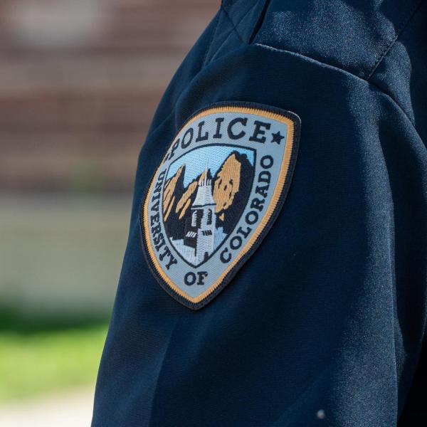 A CU Boulder police department emblem on a shirt sleeve.
