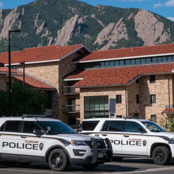 Two police vehicles are parked on the CU Boulder campus. (Patrick Campbell)