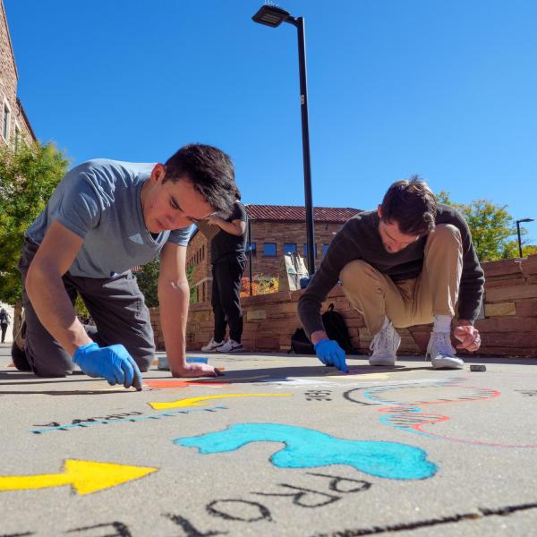 Daniel Yoshimura (Left) and Ryan Fritts, collaborate on the design of their chalk art during UROP’s Sidewalk Symposium.
