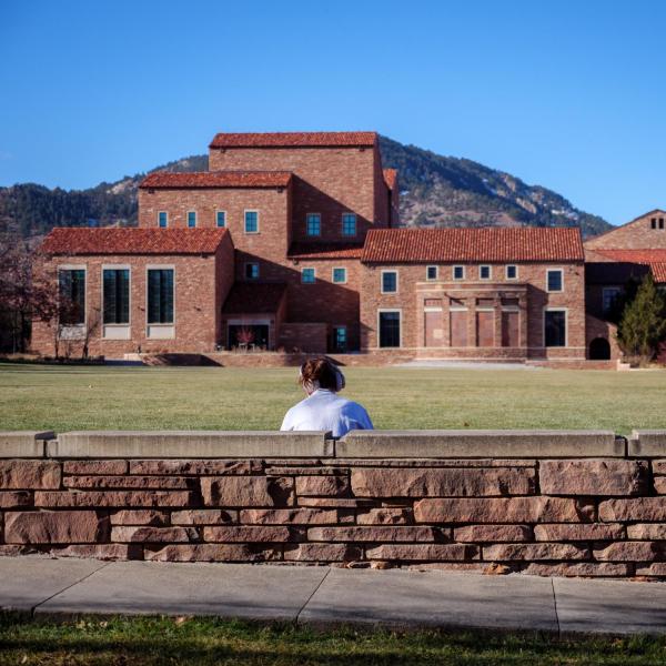 Student studying near the music building