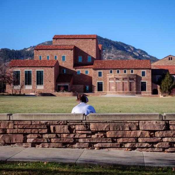 campus community member sitting outside