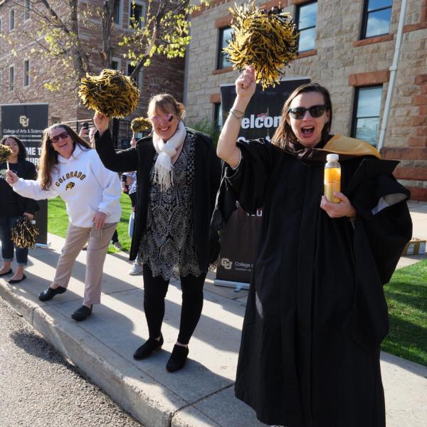 Students, parents, families, faculty, staff, guests and leadership cheer on 2022 graduates as they process to Folsom Field