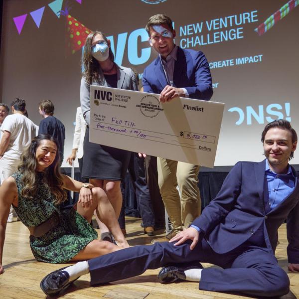 Full Tilt Motion Labs entrepreneurs pose with their $5000 check at the 2022 New Venture Challenge championships at the Boulder Theater on April 12, 2022. Clockwise from bottom left: Jamie Voros, Christen Malloy, Robert Olson and Glenn Holzhauer. (Photo by Glenn Asakawa/University of Colorado)