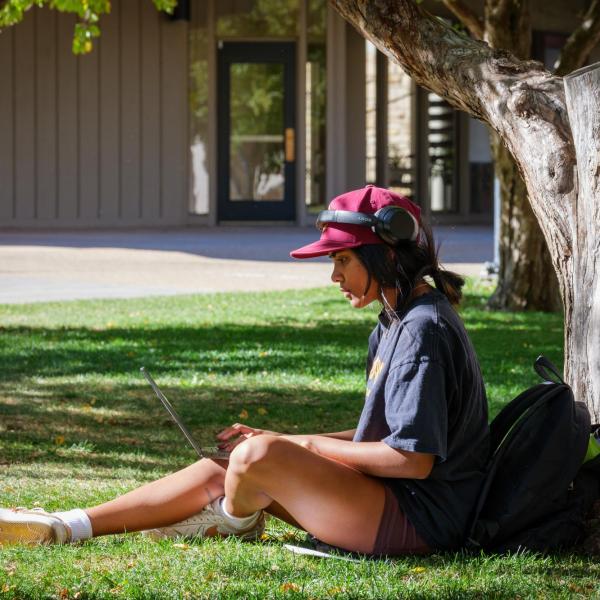 student on a laptop outside
