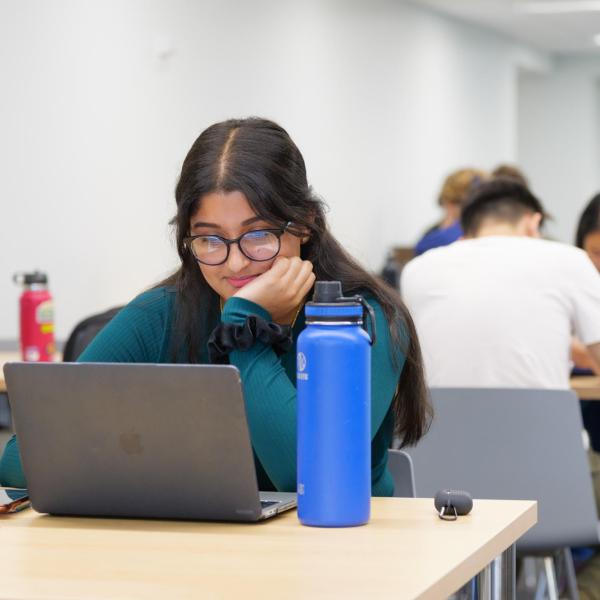 People working on laptops on campus
