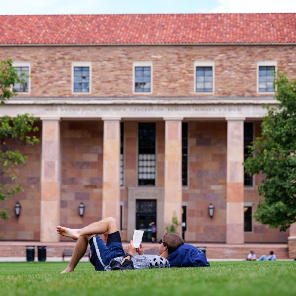 Charles Lipscomb, Grad student in Aerospace Engineering, reads a book while enjoying the nice weather. Photo by Patrick Campbell/University of Colorado
