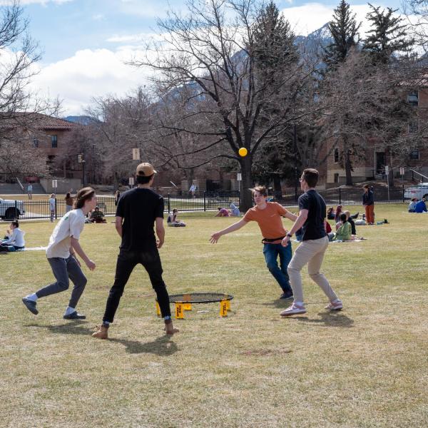 Students playing a game on Norlin Quad