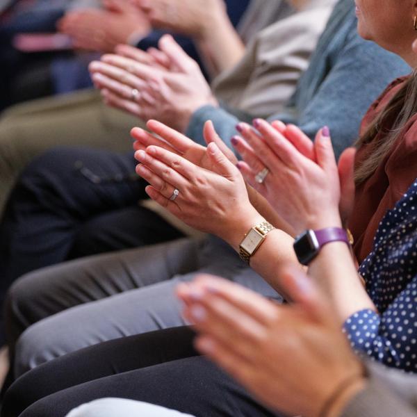 People clapping during a presentation