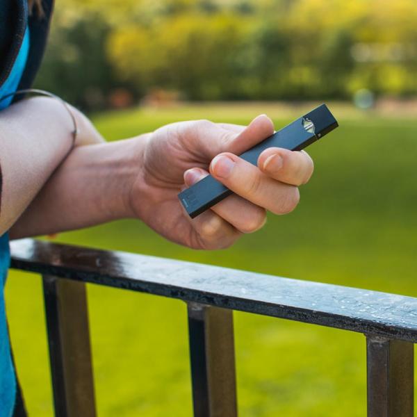 person holding Juul vape