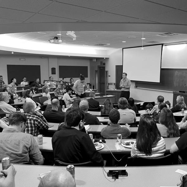 a presenter speaking to attendees