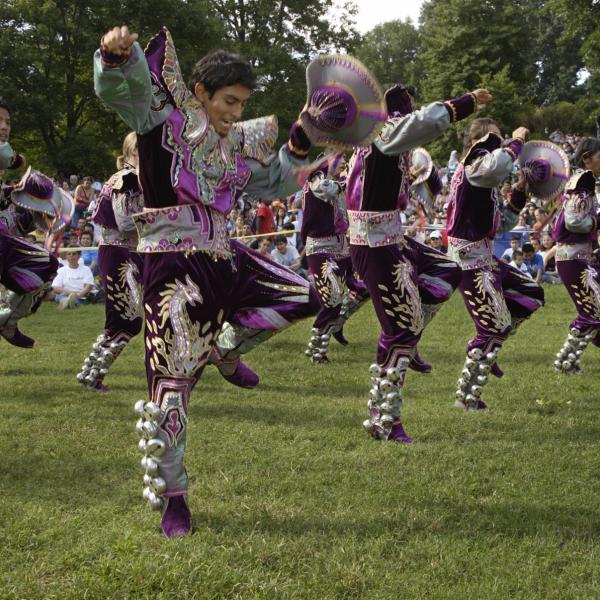 Hispanic people dancing in traditional clothes