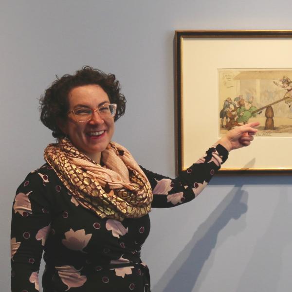 Hope Saska, curator at the CU Art Museum, points to a print from the Bawdy Bodies exhibit
