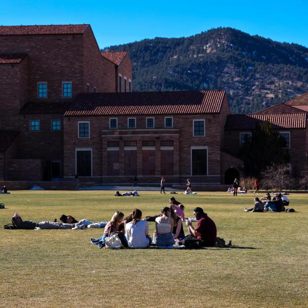 Students sitting in a circle outside