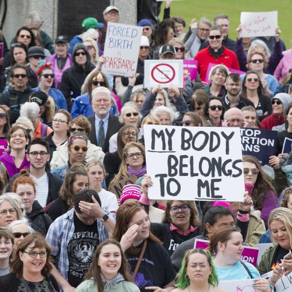 group of people marching to protest abortion ban
