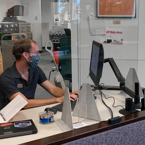 A library worker at their desk