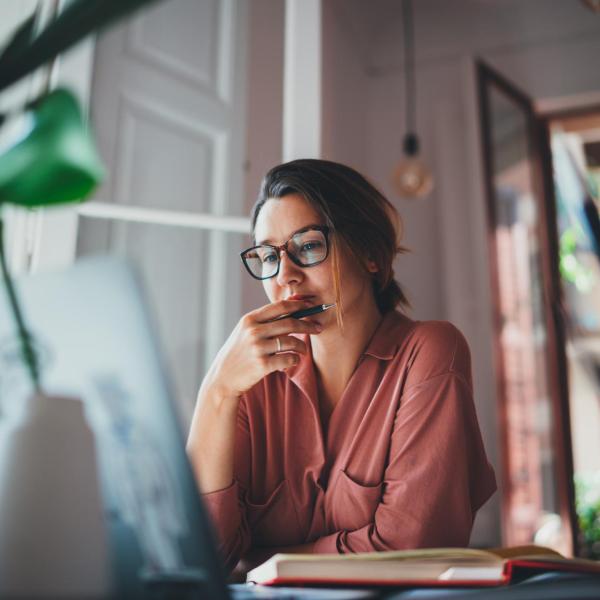 person thinking about something while sitting at a computer