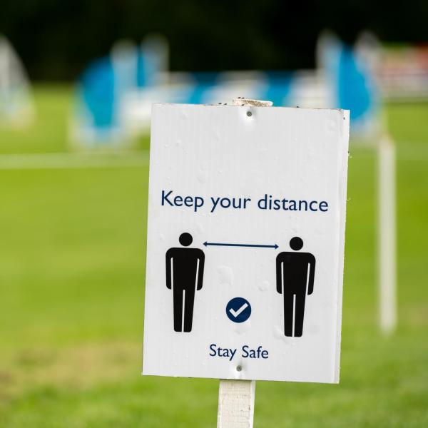 a sign that says keep your distance