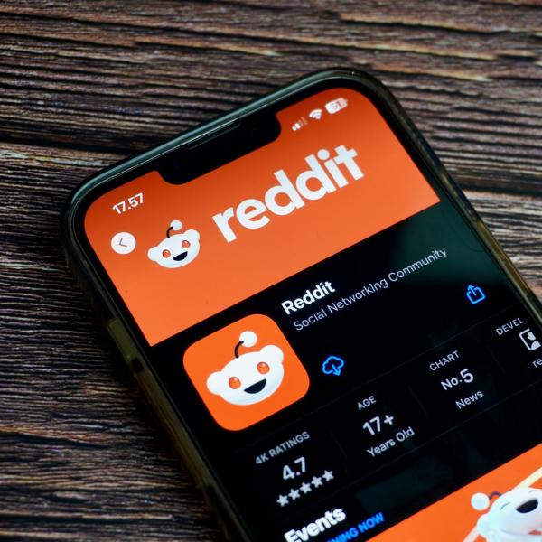 Photo of a smartphone with the screen displaying the Reddit app in a store
