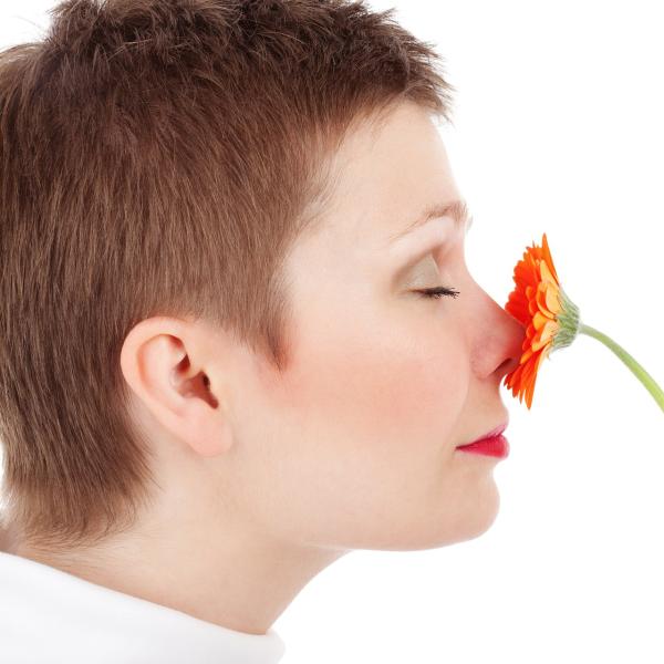 A woman smelling a flower
