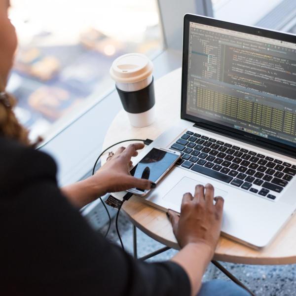 Person coding on laptop computer