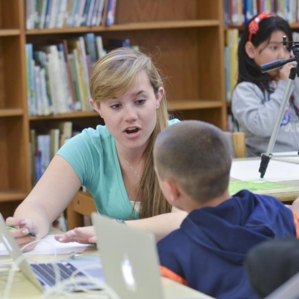 CU students helps Sanchez Elementary students with STEM projects as part of the El Pueblo Magico program. (Photo by Glenn Asakawa/University of Colorado)