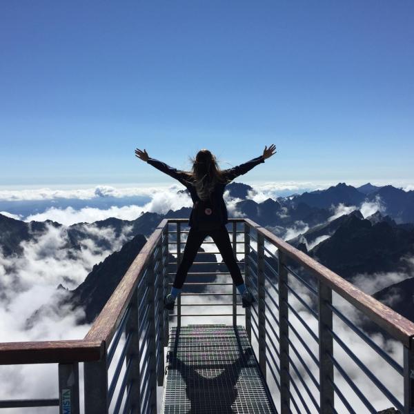 Woman on a mountain top.