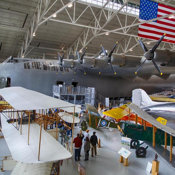 Visitors look at planes at the Wings Over the Rockies Air and Space Museum