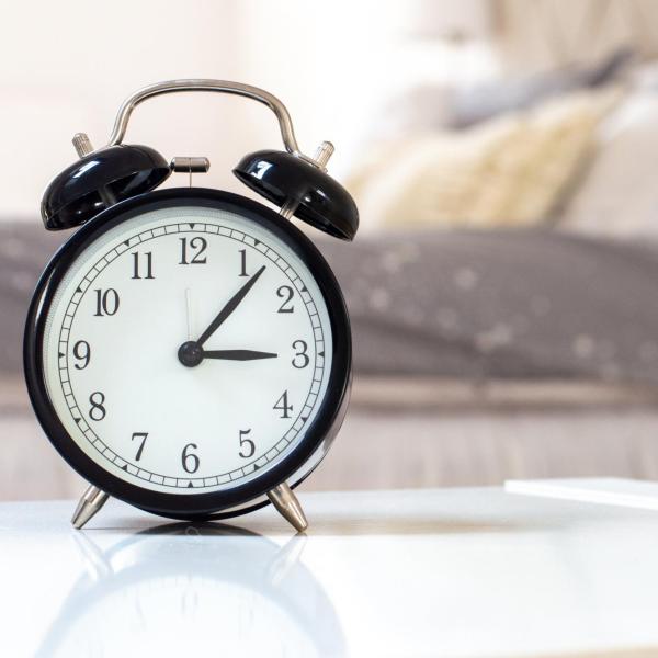 Analog alarm clock in bedroom