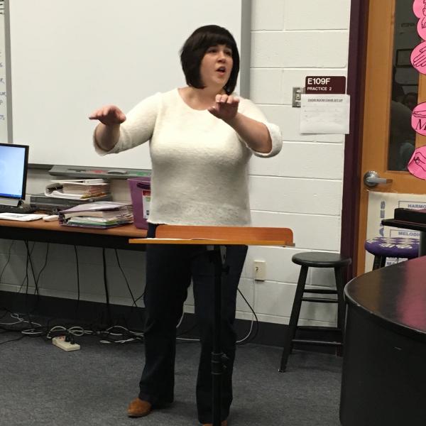 CU Boulder Associate Director of Choirs Andrea Ramsey conducts song during rehearsal