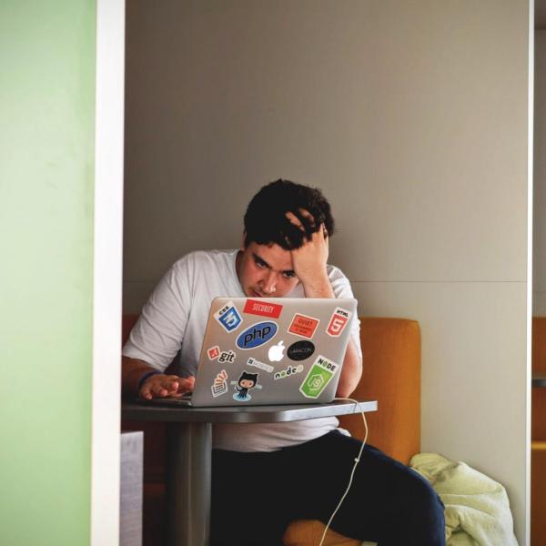 Stressed out student works at computer