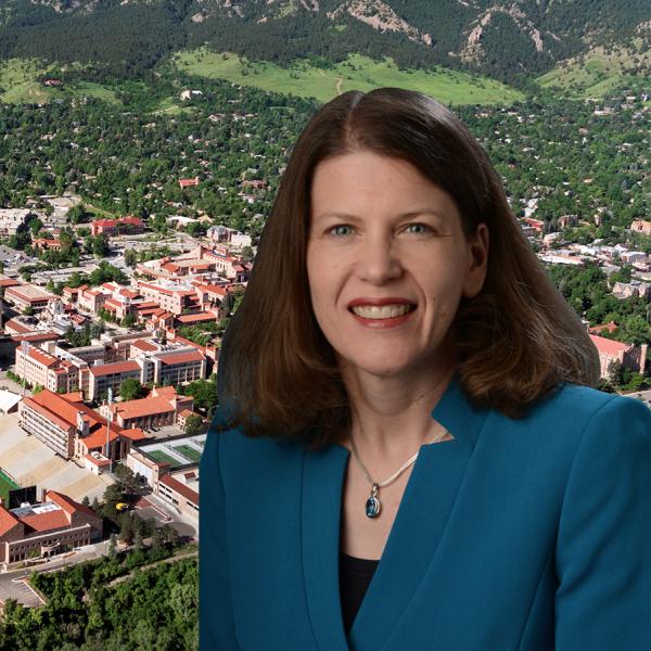 Ann Schmeising portrait with an aerial view of the cu boulder campus in the background