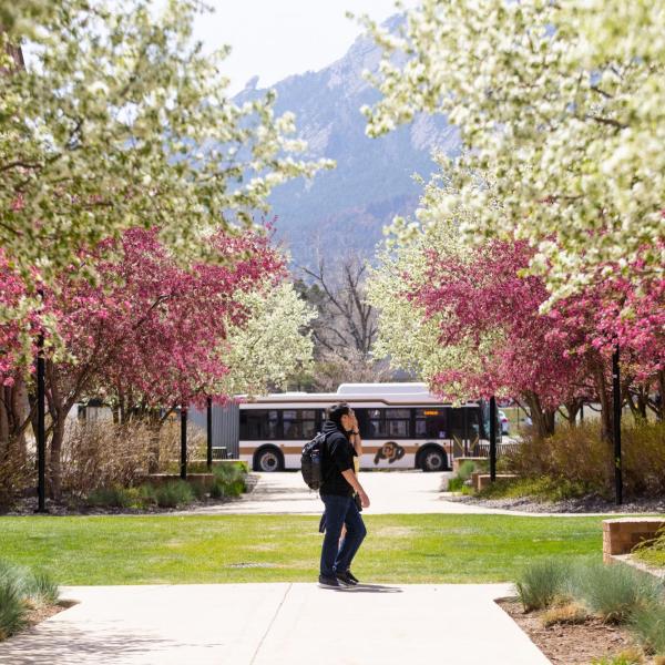 Students on campus in April, with spring blooms all around