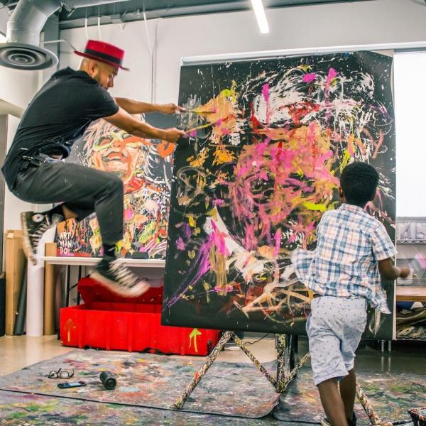 Armando Silva painting on a canvas