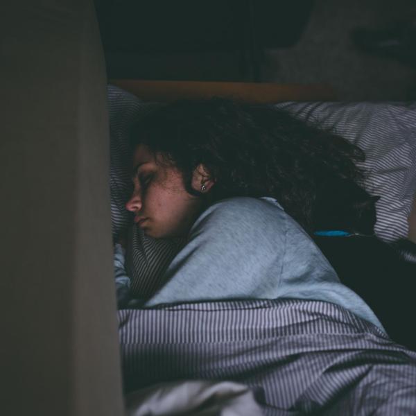 Woman sleeps in dark room
