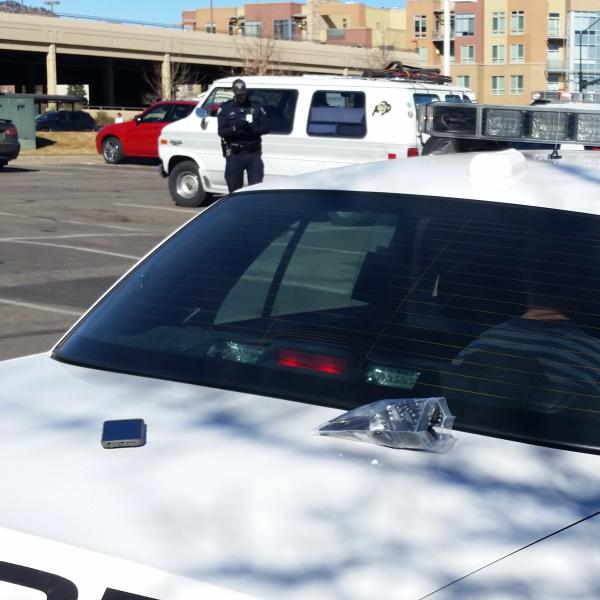 Police officer stands next to white van