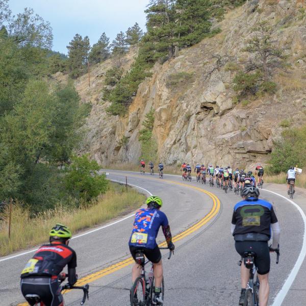 Bikers riding up a canyon.