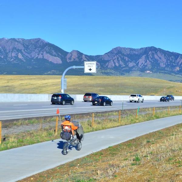 West bound traffic and a west bound bicyclist make their way into Boulder