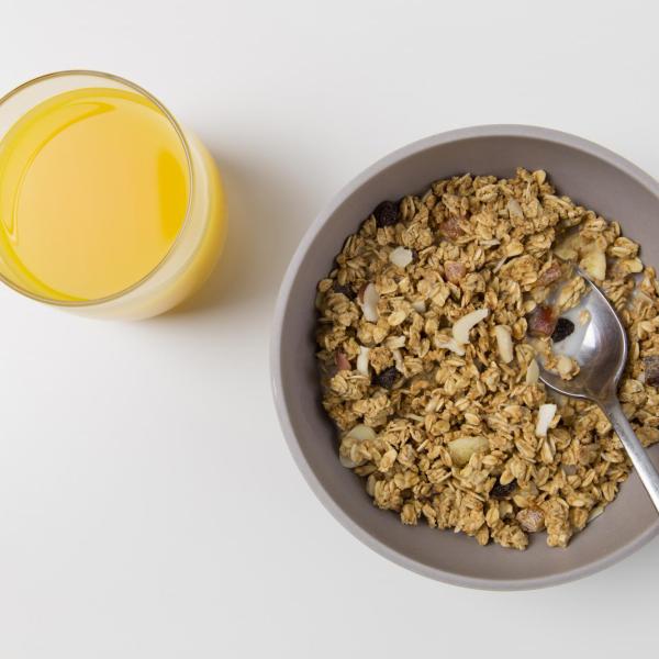 Bowl of healthy cereal and glass of orange juice
