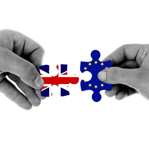 British and European Union flag pieces are held side by side.